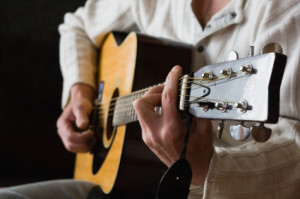 Man Playing on guitar on the dark background